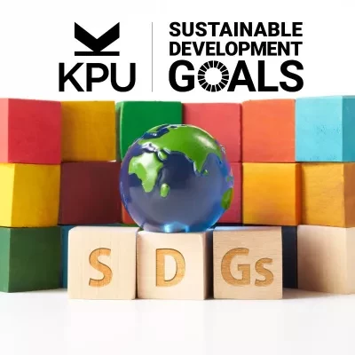 KPU Sustainable Development Goals above three rows of colourful blocks stacked behind 3 wooden blocks that say "SDG". A globe sits on top of the three blocks with "SDG".