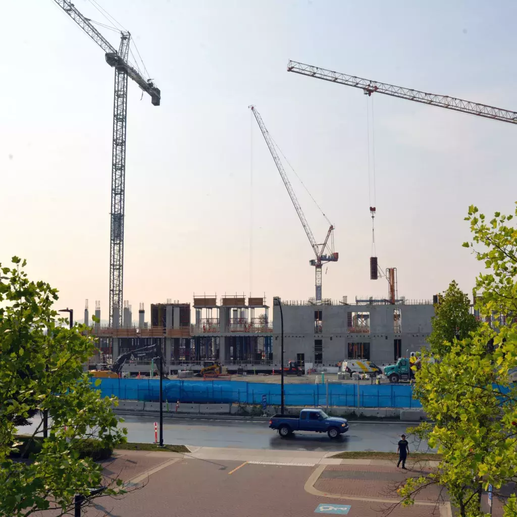 Cranes tower over a hospital construction site.