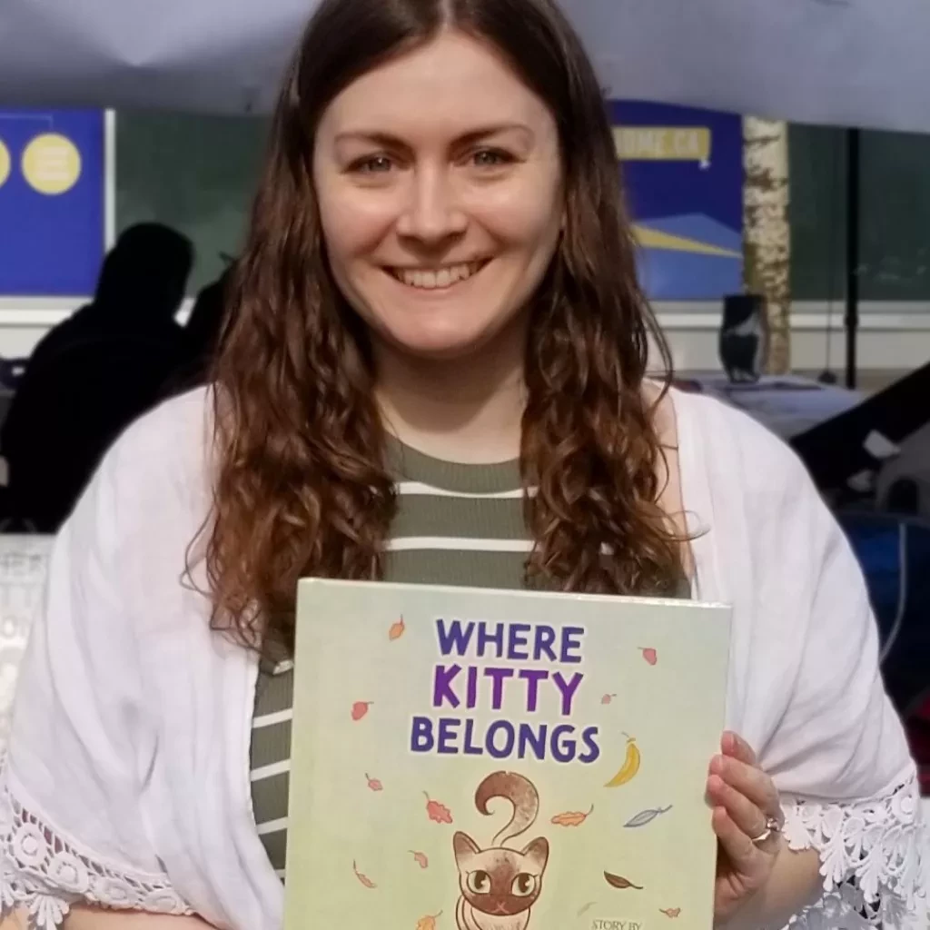 Chantal Houle holding book Where Kitty Belongs.