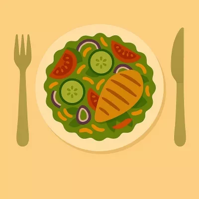 Plate of salad with cucumbers, chicken and tomatoes on a yellow background with a fork and knife beside the plate
