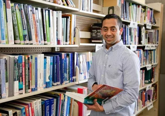 A person holding a book in the library