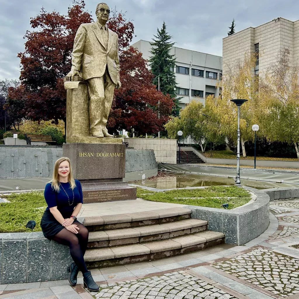 Dr. Kelly Doyle sits in the main campus square at Bilkent University.