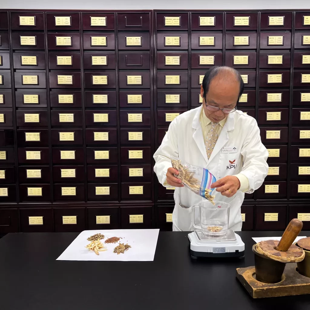 Dr. John Yang in the herbal dispensary at KPU.